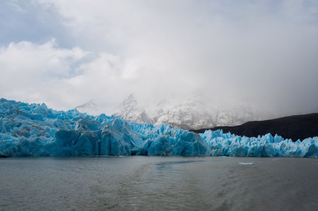 Dramatic granite peaks of Torres del Paine reflecting on a serene turquoise lake in Patagonia
